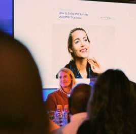 Speaker presenting to a seated audience at an industry event
